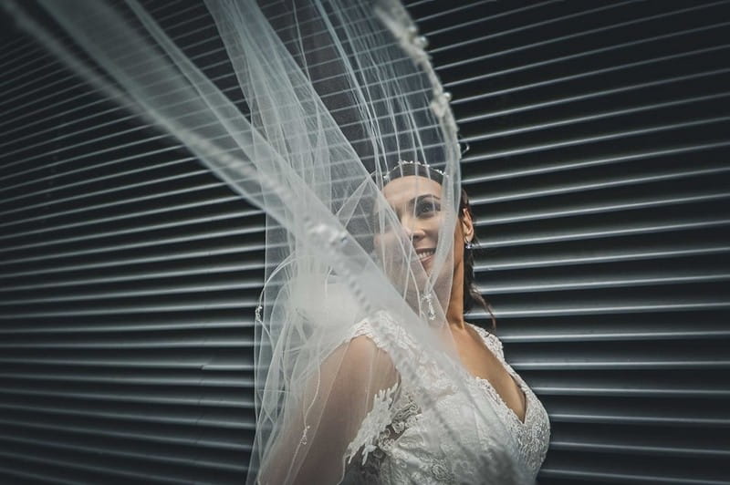 Bride with veil blowing over her face - Picture by Paul Kyte Photography