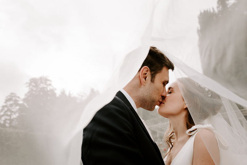 Bride and groom kissing under bride's veil - Picture by Michelle Cordner Photography