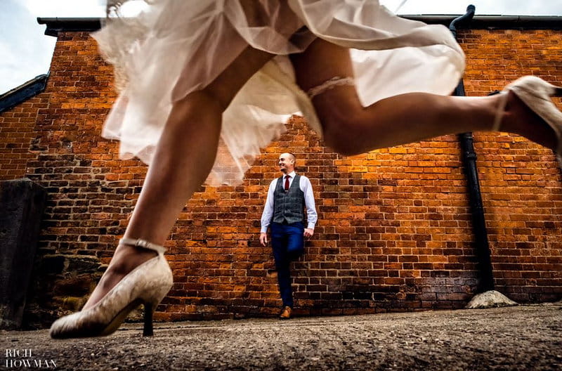 Groom standing against wall as bride's legs run past - Picture by Rich Howman