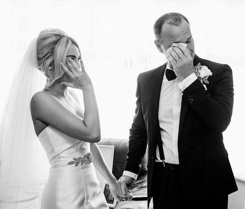 Bride and groom both wiping away tears - Picture by Focal Point Photography