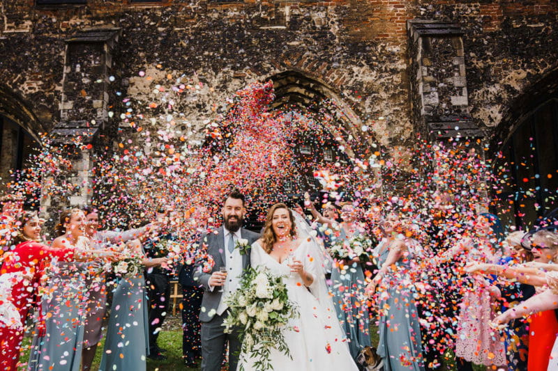 Bride and groom being showered in lots of confetti - Picture by Rob Dodsworth Photography