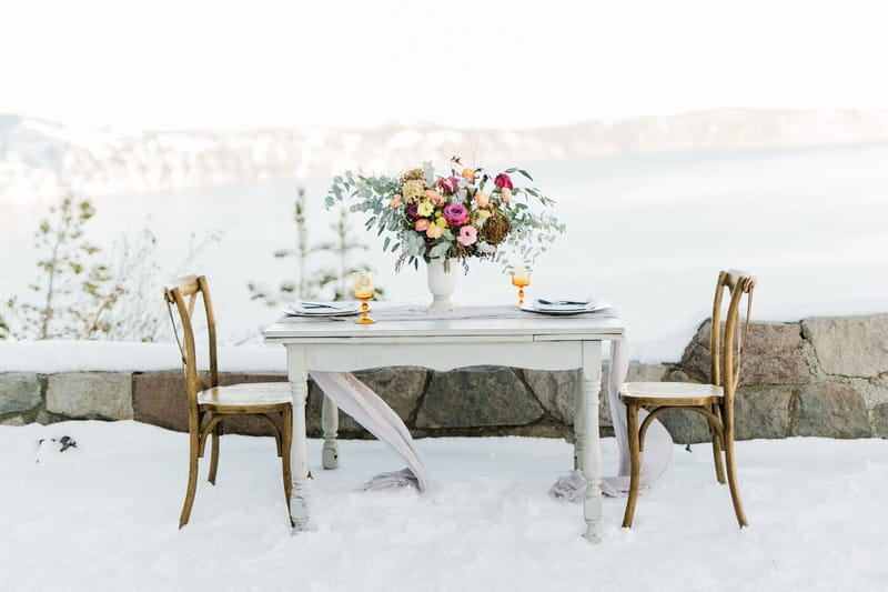 Flowers on elopement table in snow