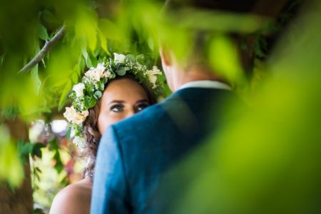 Bride with flower crown staring into groom's eyes - Picture by Nick Church Photography