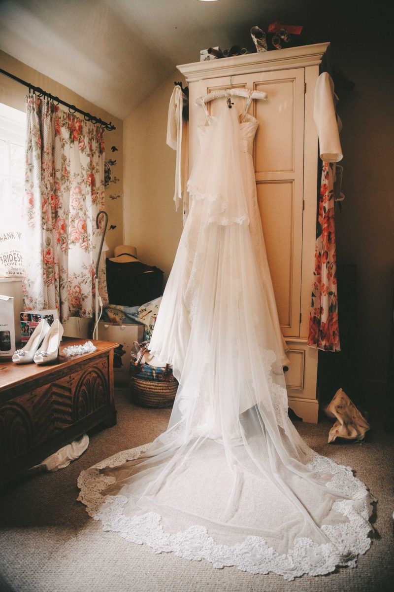 Wedding dress hanging on wardrobe