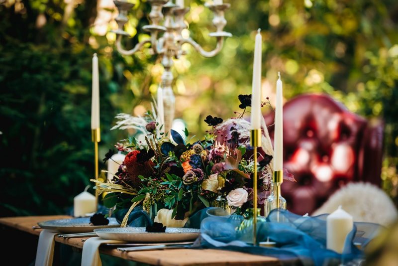 Flowers on wooden wedding table in woods