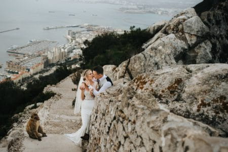 Bride and groom kissing next to monkey - Picture by IG Time Photography