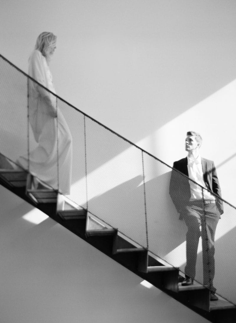 Groom standing on stairs as bride walks down - Picture by Matthew Moore Photography