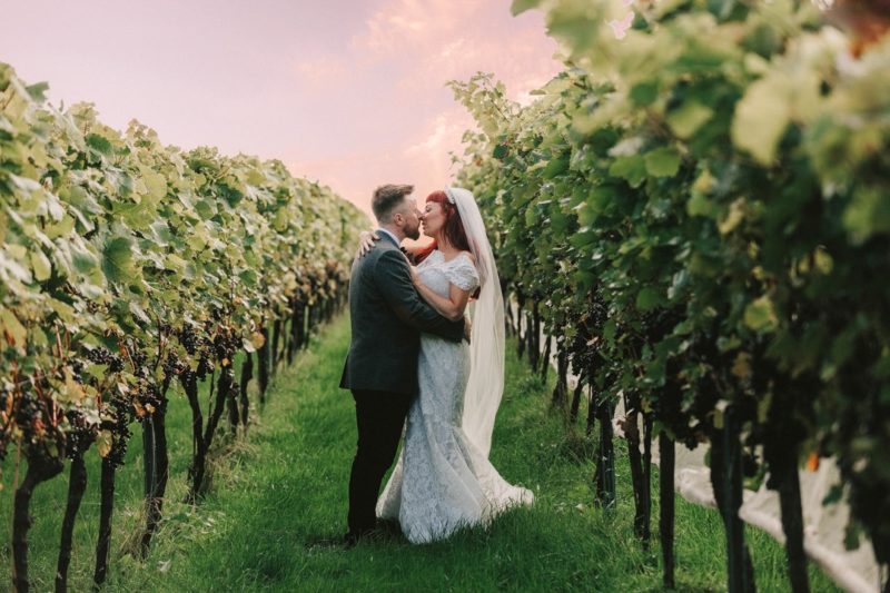 Bride and groom about to kiss in vineyard - Picture by Andrew George Photography