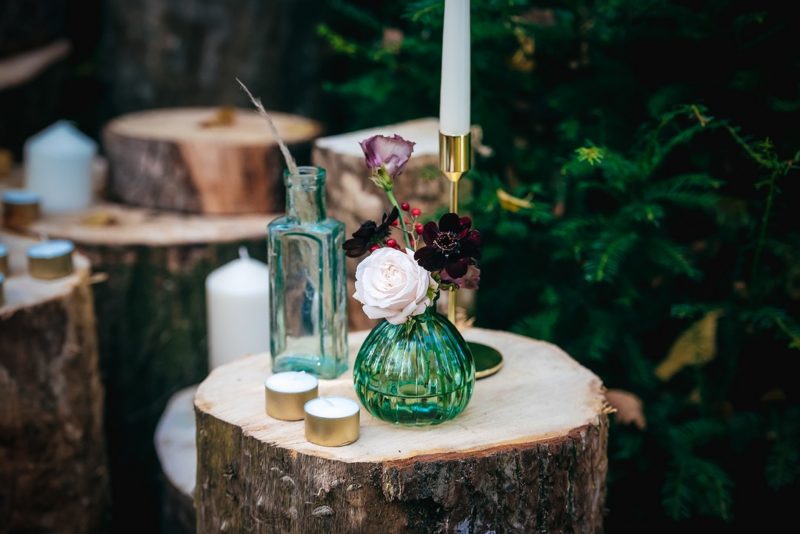 Glass vases on wooden stumps