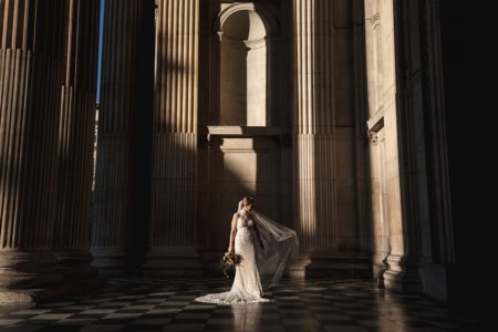 Bride standing in entrance to St Paul's Cathedral - Picture by Rik Pennington Photography