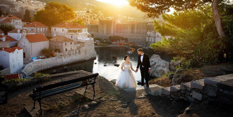 Bride and groom walking up steps in front Pile Gate in Dubrovnik,Croatia - Picture by Ciprian Biclineru