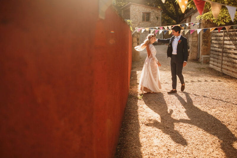 Bride and groom next to wall in sunshine - Picture by Stephen Walker Photography