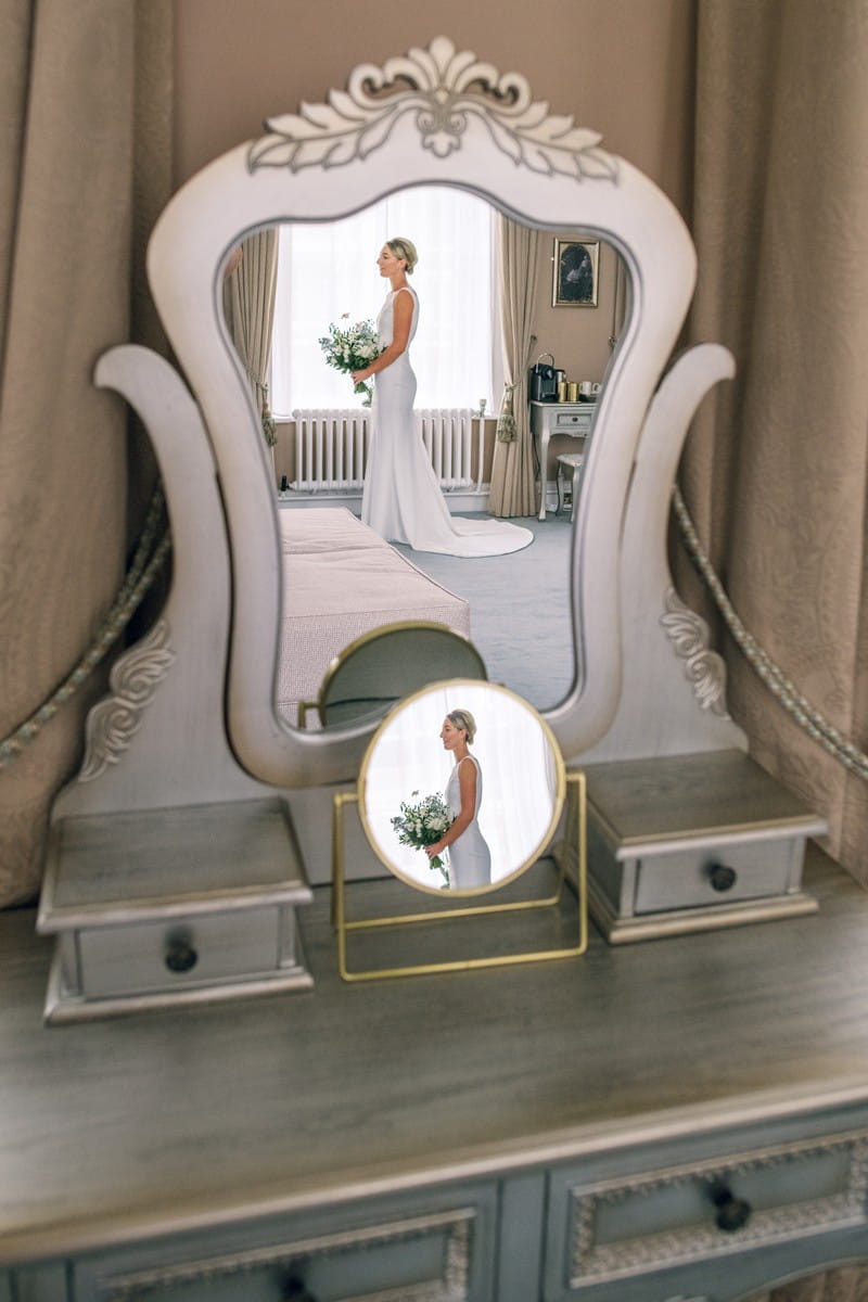 Reflection of bride in two mirrors