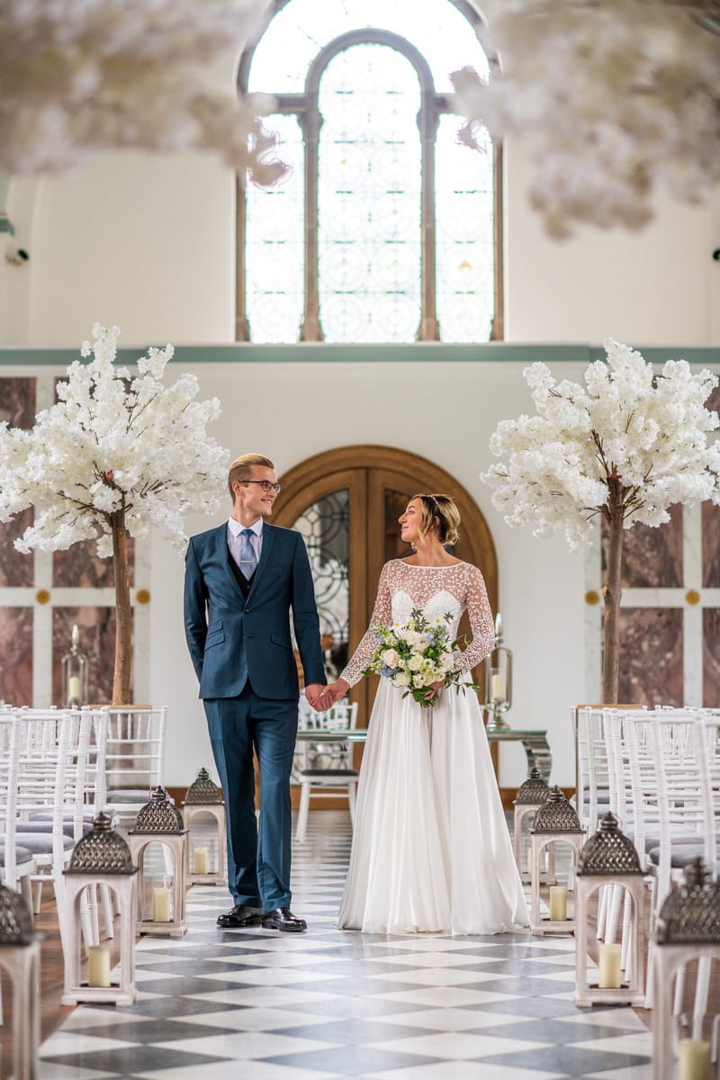 Bride and groom walking down the aisle in The Chapel at Hawkstone Hall