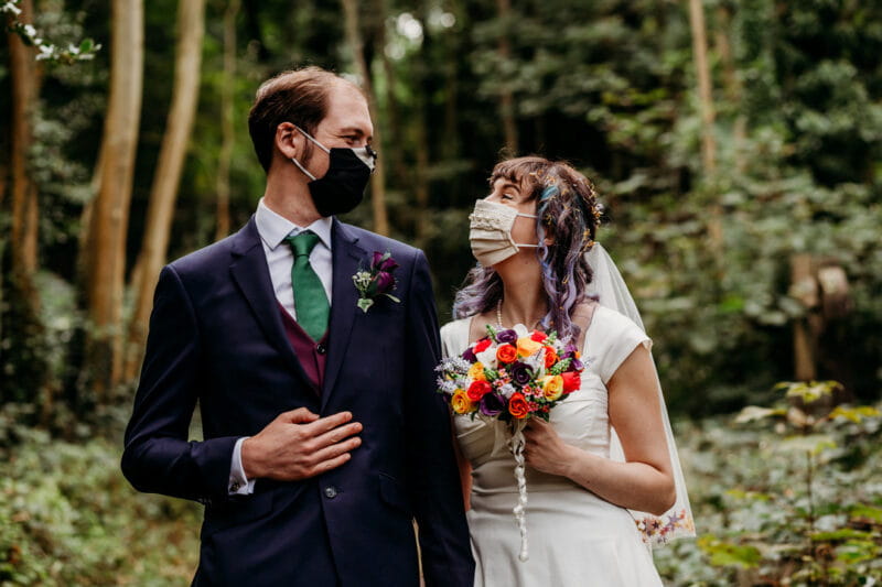 Bride and groom wearing face masks looking at each other - Picture by When Charlie Met Hannah