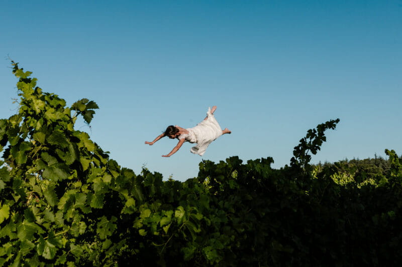 Bride flying through the air over bush - Picture by Alison Bounce Photography