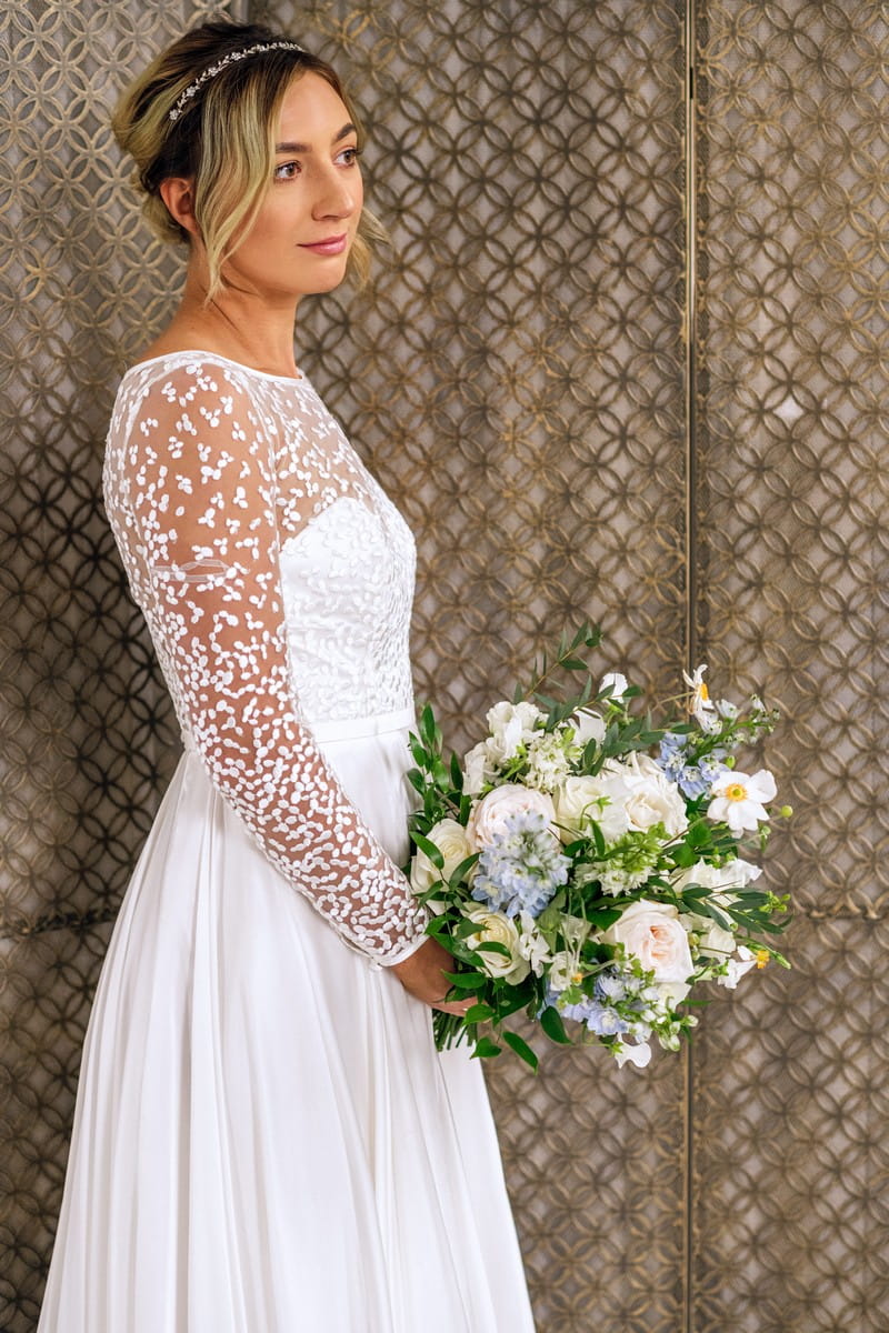 Bride wearing wedding dress with patterned sleeves