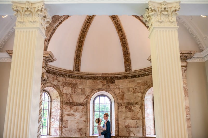 Bride and groom by window of The Tapestry Room at Hawkstone Hall