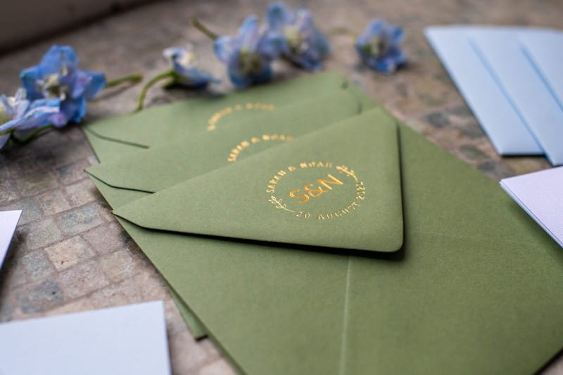 Green envelope with gold wedding motif