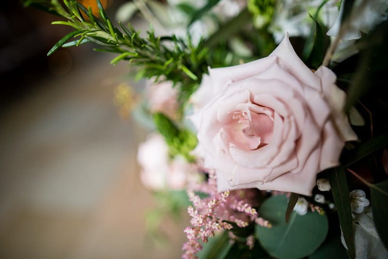Pink rose and rosemary in wedding flowers