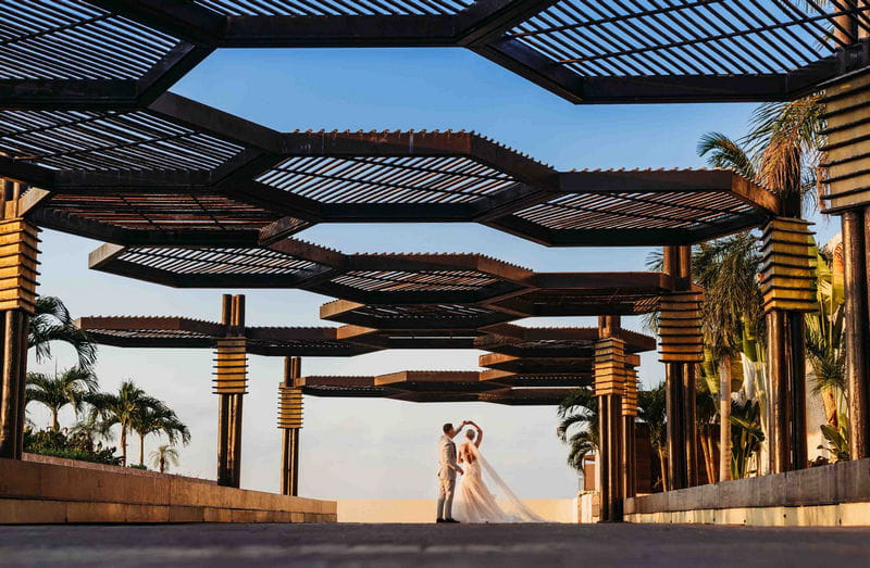 Groom twirls bride under hexagons outside Royalton Riviera hotel - Picture by Martin Cheung Photography