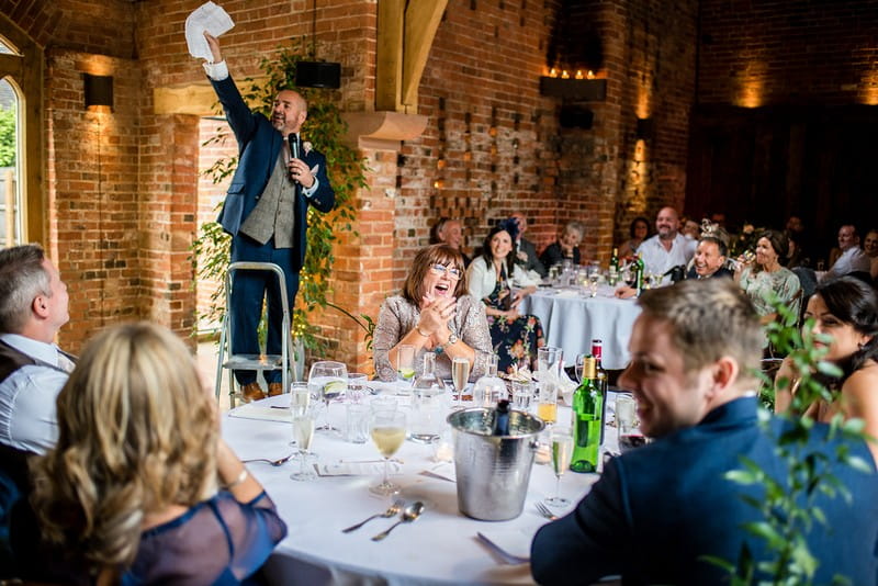Man standing on step ladder to give wedding speech