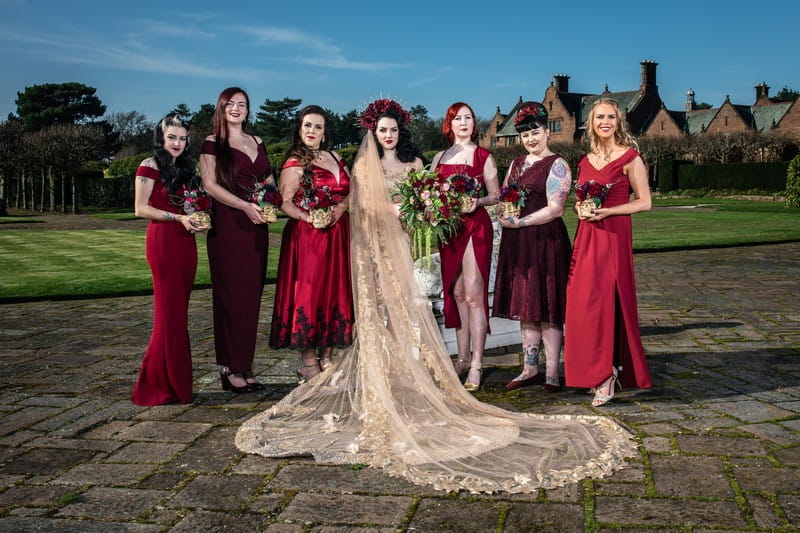 Gothic bride with bridesmaids in red dresses