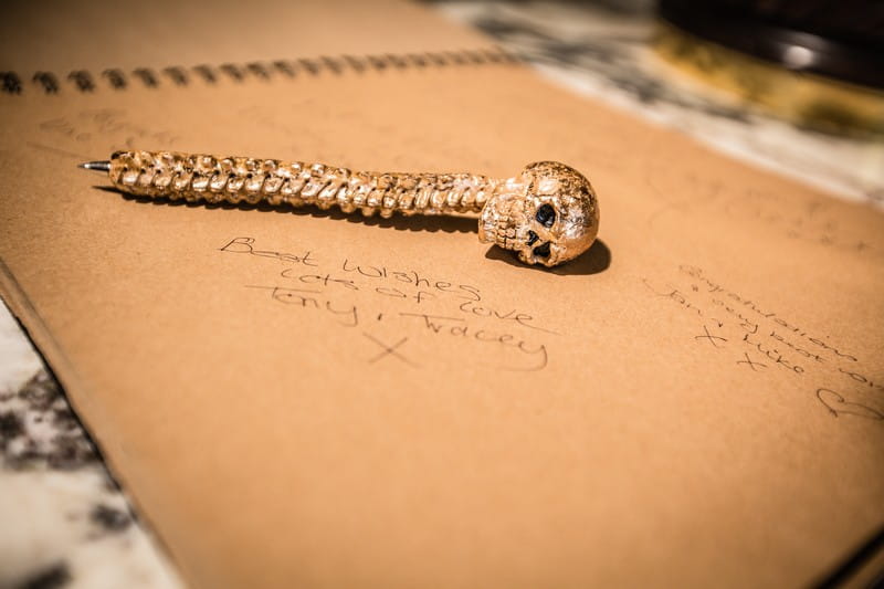Skull pen on top of wedding guest book message