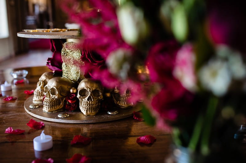 Gold skulls at base of wedding cake