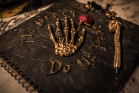 Gothic wedding guest book with skeleton hand on front