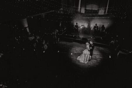 Bride and groom under spotlight on dance floor - Picture by Good Luck Wolf Photography