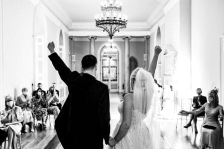 Bride and groom punching the air after wedding ceremony - Picture by Jonny Barratt Photography