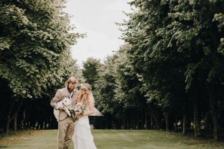 Bride and groom holding dog - Picture by Katie Goff Photography