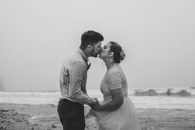 Bride and groom kissing in front of the sea - Picture by Tracey Warbey Photography