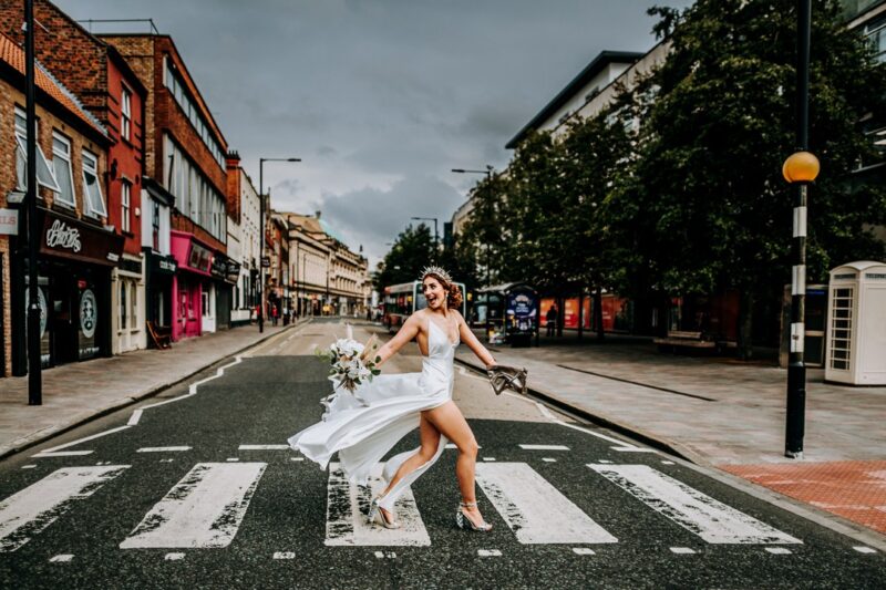 Bride walking across zebra crossing - Picture by M and G Wedding Photography