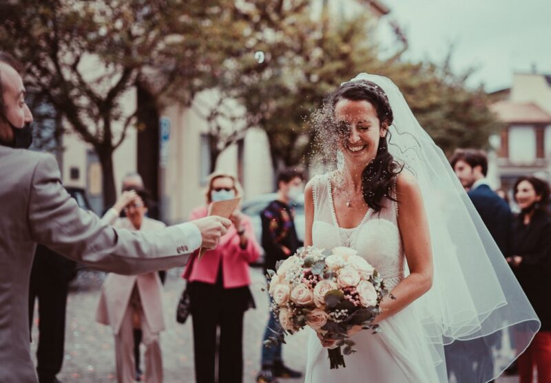 Bride being hit in the face by confetti - Picture by Anna Pierobon Photography