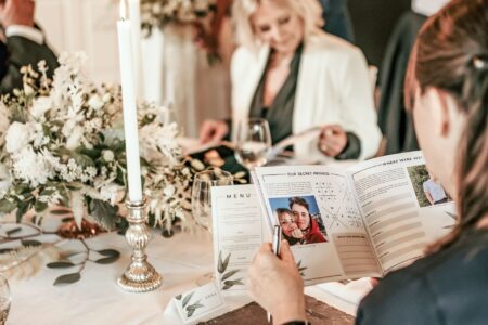 Wedding guest reading Love Story booklet from CherryTop Weddings