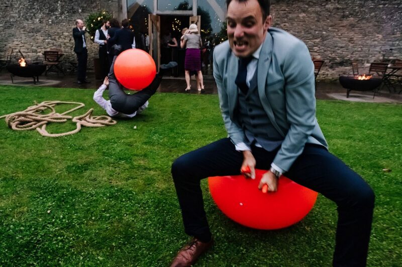 Two men bouncing on Space Hoppers at wedding - Picture by Kristian Leven Photography