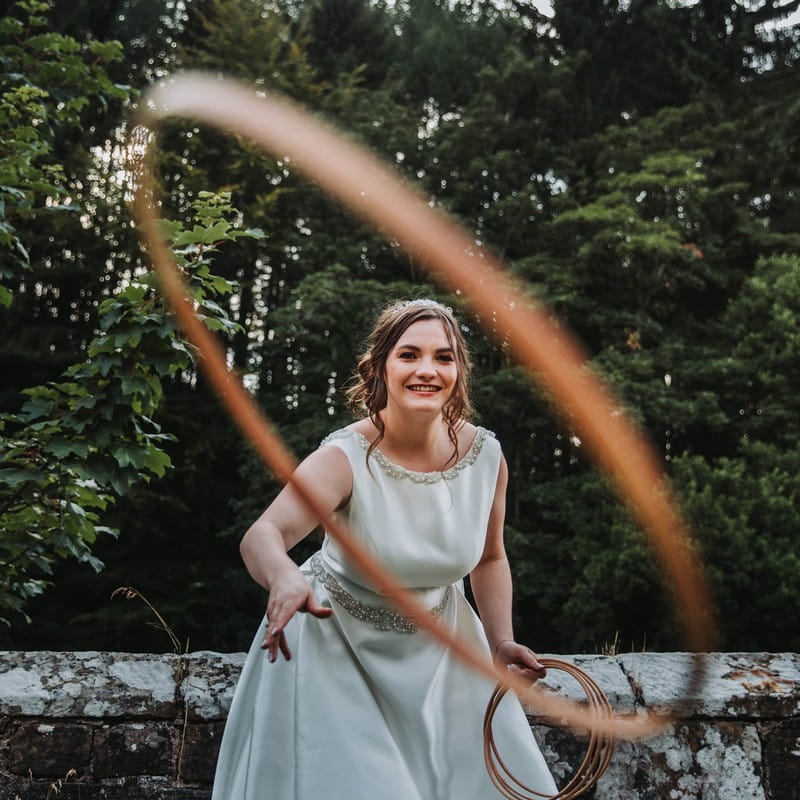 Bride throwing hoop at camera - Picture by David West Photography