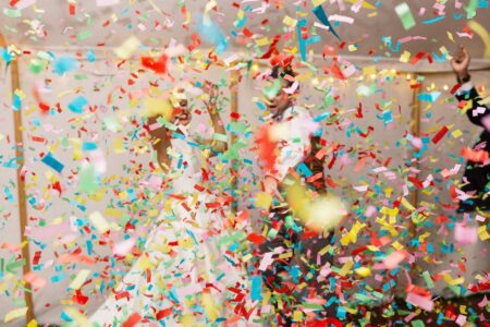 Bride and groom dancing behind colourful confetti - Picture by Paul Joseph Photography