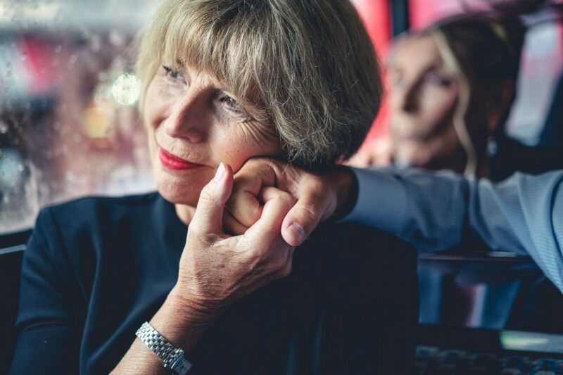 Wedding guest lovingly holding man's hand to side of her face - Picture by Andrew Billington Photography