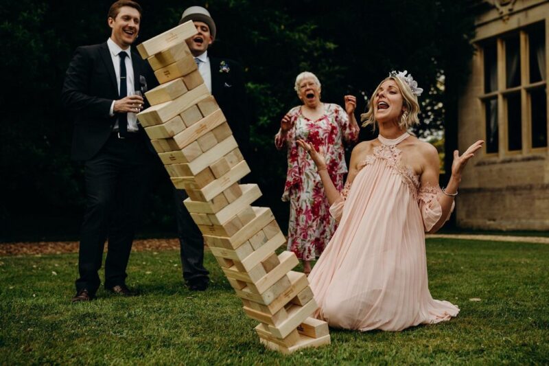 Bridesmaid on her knees shouting as Jenga tower topples over - Picture by Richard Skins Photography