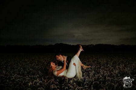 Groom carrying bride in wheat a field at night - Picture by Embee Photography