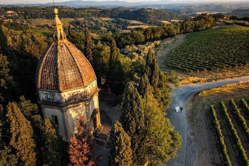 Bride and groom walking down road in Tuscany countryside - Picture by D2 Photography