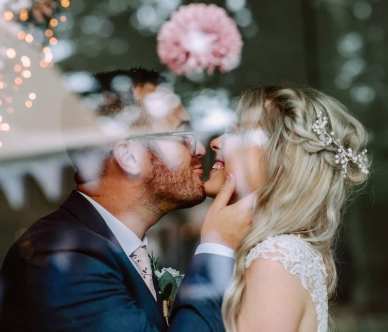 Bride laughing as groom is about to kiss her - Picture by Eva Murko Photography