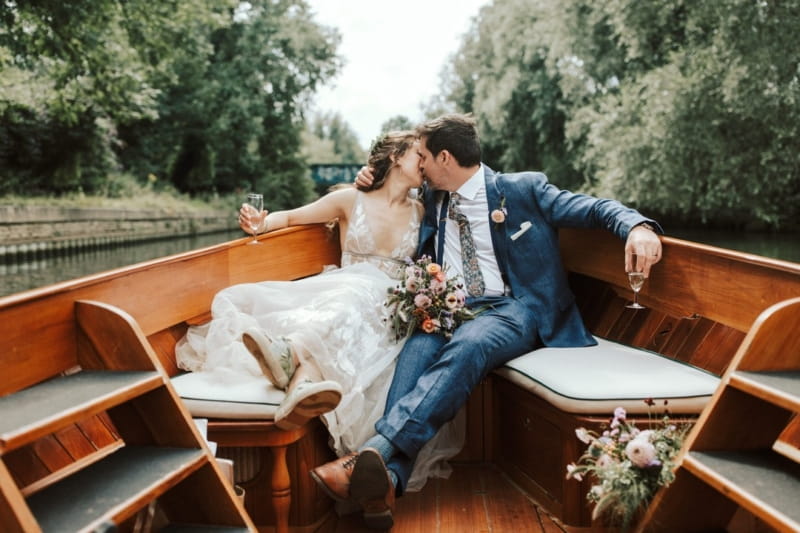 Bride and groom kissing on the back of a boat - Picture by Lianne Gray Photography