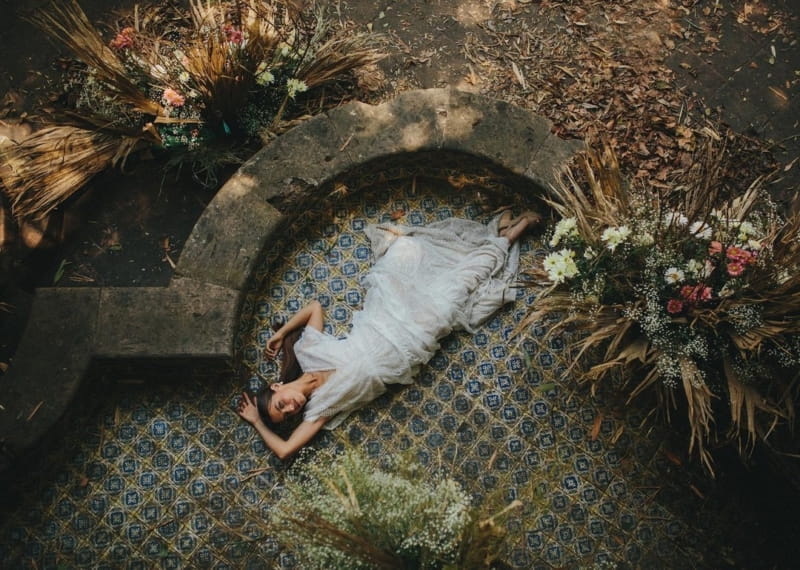 Bride laying on tiled floor outside - Picture by Petar Jurica Photography