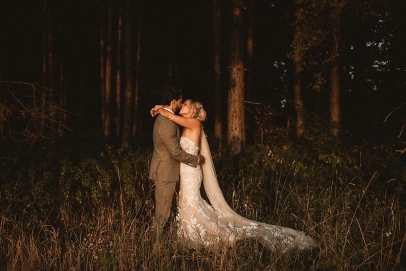 Bride and groom kissing in woodland at night - Picture by Shaun Walker Photography